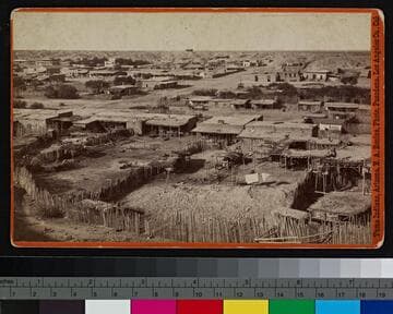 View of a Yuma Indian village in Arizona, showing adobe and brush dwellings