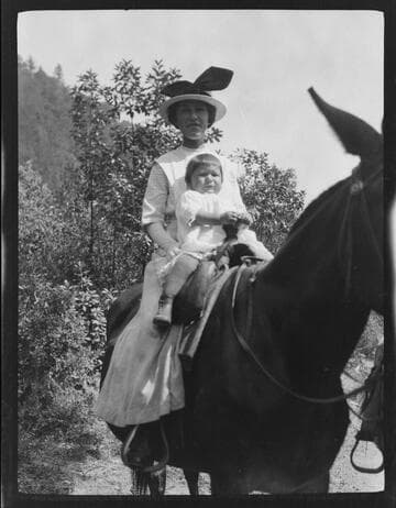 An unidentified Native American woman and baby sitting on a horse
