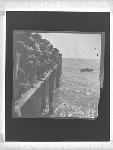 Crowd peering off of the North Beach Bath House Pier