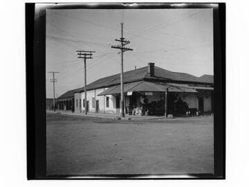 Store in adobe building with merchandise outside on street corner