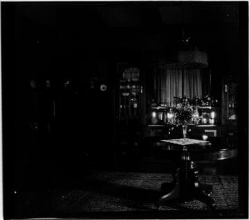 Unidentified house interior with flowers on table