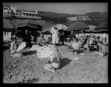People playing with large cards on the beach, Santa Monica