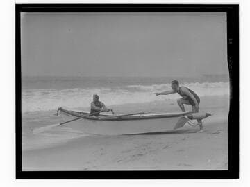 Coach and instructor taking a lifeboat out on the water for lifeguard training, Santa Monica