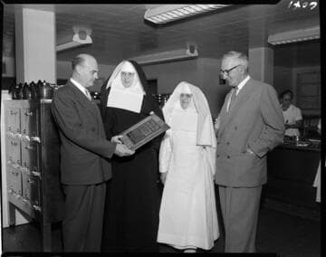 Saint Francis Hospital nuns receiving Merit Award from Institutions Magazine in hospital kitchen
