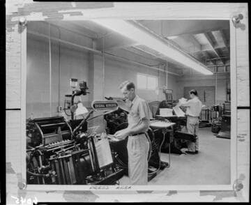 Men working in the pressroom of the Ledger Gazette