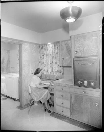 Lady seated at valet in her all electric kitchen