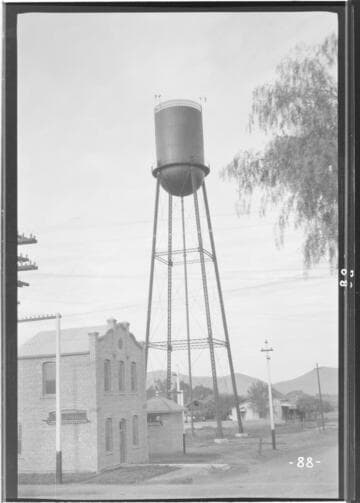 View of the Porterville water storage tank next to the substation with mountains and residences in the background