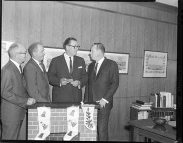 Executives posed exchanging checks