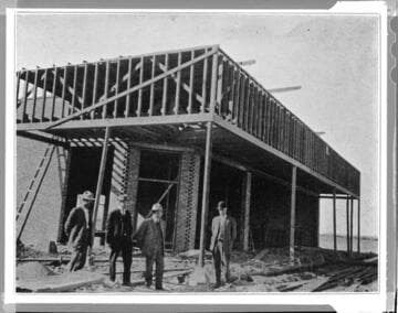 Four men at a building construction site