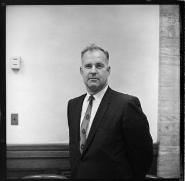 Three people reviewing document at desk