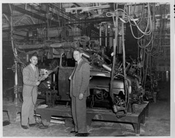 Wayne Johnson (right) views welding equipment at Ford's Wilmington Assembly Plant, during the conversion to 60-cycle operation, 1947