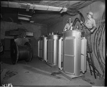 Men working in underground transformer vault