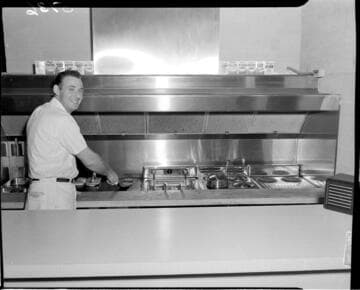 Man grilling burgers kitchen