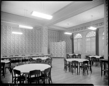 Formal dining room with round tables and long banquet table