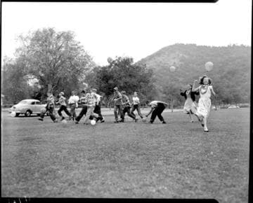 Kids in the park in a balloon race