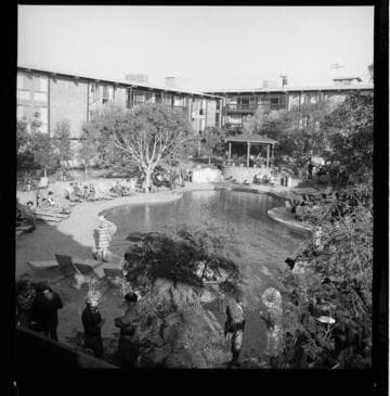 All-electric building award presented during a party/buffet at a hotel courtyard and pool area
