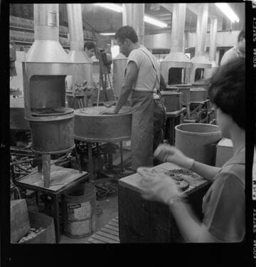 Manufacturing plant with workers forging