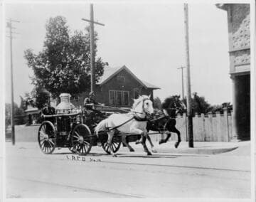 Los Angeles Fire Department Engine #14 at full speed on a city street,  ca. 1910