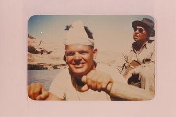 Boatman George Wing at the oars.  Max Krueger in background.  Max was regional geologist for Union Oil