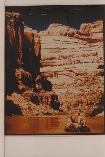 Bus Hatch running a motor on a 10-man inflated boat.  Four miles below Mantle's Ranch on the Yampa River