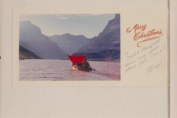 [Christmas card, 1963]  Buzz Belknap under sail with plastic poncho, Sportyak II.  Lake Mead in the lower end of Grand Canyon