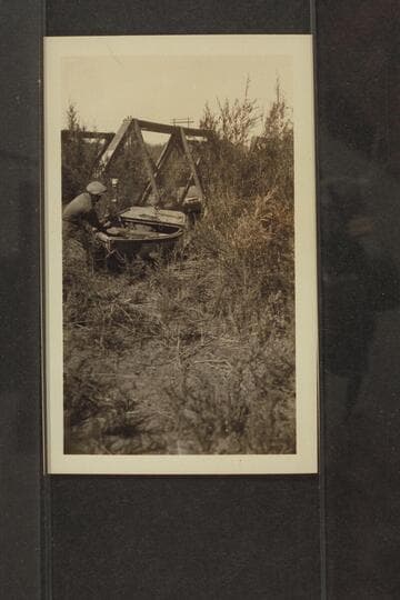 Dragging boat around a low bridge on the Alamo