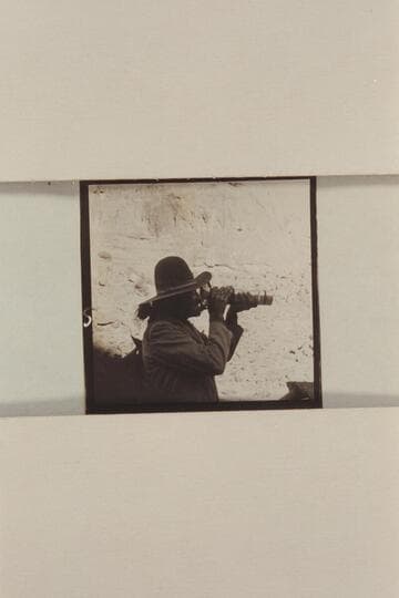 Buck White-hat, Navajo Indian guide.  Ch'ahlgaii.  Finding the white man's aid to sight can be amusing