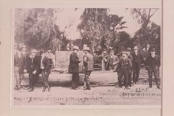 The "Utah" at Needles.  Charles Russell stands right center and talking with the man in front of the sign.  The sign is the after deck of the skiff